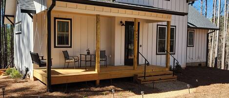 Large front porch with chairs and porch swing for lounging