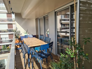 ouside dining space with plants and lights