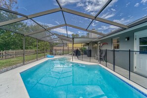 Backyard and patio with pool, grill, fire pit and outdoor furniture.