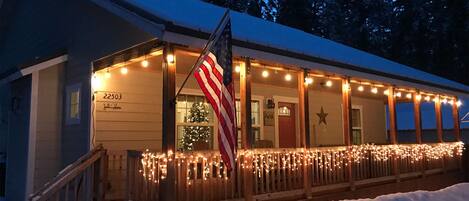 Welcoming front porch with seating and a gas fire pit.