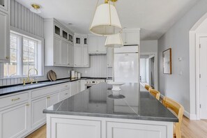 Remodeled kitchen. Cabinet panel will go on refrigerator and freezer.