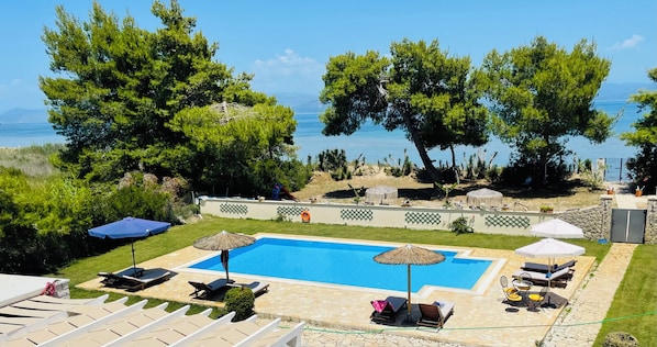 view from upper balcony across the pool and to the beach