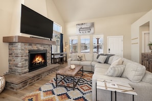 A gas fireplace and large smart TV make relaxing easy