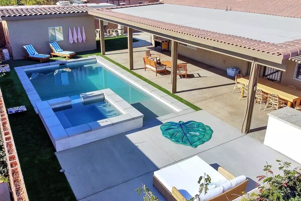 Backyard oasis! Heated pool/spa with a variety of pool floats and seating areas