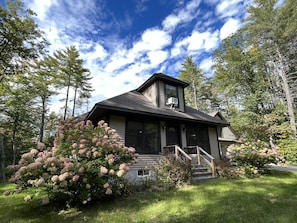 Front of the house is flanked by enormous hydrangeas as seen from the front yard