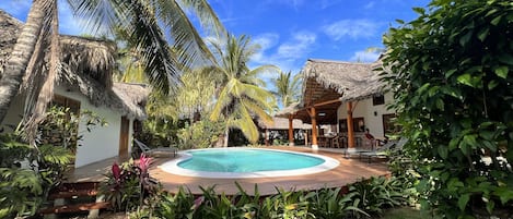 Main Villa to right with pool in the middle with the two bungalows on the left