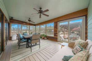 The ultimate relaxation spot by the water | Sun porch with dining room table
