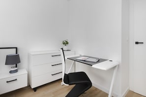 Compact workspace with a desk, chair, and stylish storage, ideal for remote work or studying.