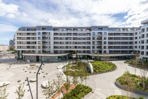 Exterior view of the residential complex, showcasing modern architecture and well-maintained green spaces.