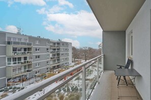 A balcony overlooking an urban area with neighboring apartment buildings.