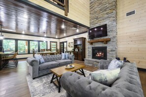 The living room is surrounded by windows to let the outside in!