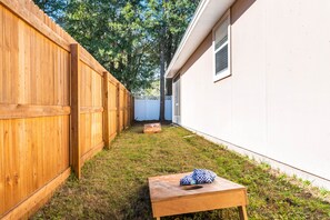 Enjoy playing corn hole with your group in this fully fenced in back yard