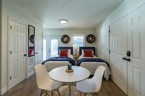 View of the room with the twin bed set up. The french doors lead to the deck.