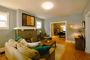 Living room, record player, tv cut off in photo. View into divining room. 