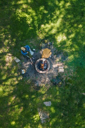 Gather around the fire pit with loved ones to build a crackling fire, roast marshmallows, and share stories. A simple, cozy space that invites connection and warmth under the open sky.