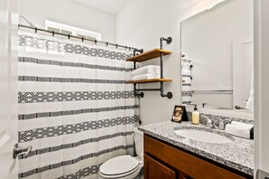 Full bathroom in first of two master suites