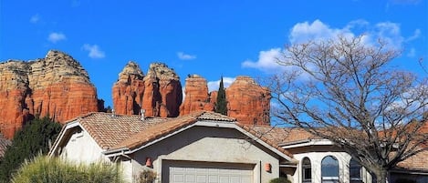 Thunder Mountain and Coffee Pot Rock stand behind the home.