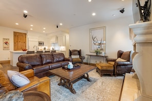 Living Room with plush leather sleeper sofa, Smart TV, and a cozy gas fireplace