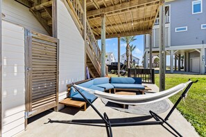 Lay on the hammock while overlooking the beach.