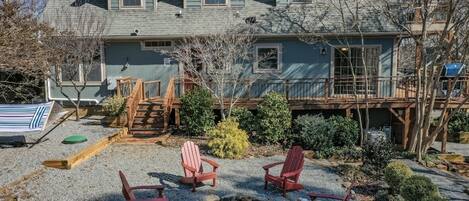Incredibly large backyard not commonly found in Lake Lure, with yard games, picnic bench, and fire pit.
