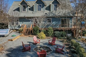 Incredibly large backyard not commonly found in Lake Lure, with yard games, picnic bench, and fire pit.