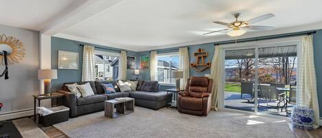 LIVINGROOM: Sofa with chaise and power recliner. Access to lake-facing patio.