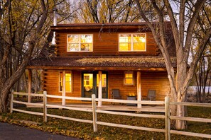 Back of the home with covered deck. 