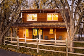 Back of the home with covered deck.