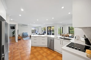 Open plan kitchen, dining and living areas.