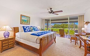 Enjoy serene golf course views from this beautifully designed bedroom, featuring a plush king bed, natural light, and direct access to a private patio for a true tropical escape.