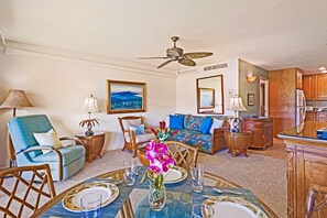 Savor delicious meals in this cozy dining area featuring bamboo-style furniture, tropical decor, and breathtaking views of the lush island landscape through floor-to-ceiling windows.