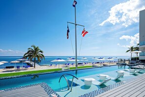 View of the resort's oceanfront pool deck. The resort's dock is equipped with a cabana and ladder for gentle water entry.