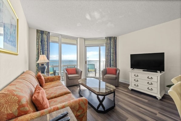 The ocean front living room is well-appointed with comfortable furnishings.
