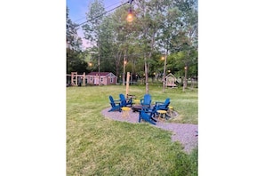 outdoor area adirondack chairs and tables surrounding fire pit area