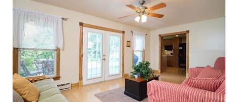 Sunlit living room with a Queen Futon and Sleeper Sofa