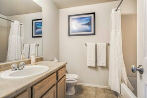 Hallway bathroom.  Equipped with tub and shower.