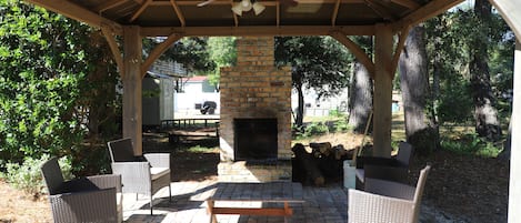 Backyard outdoor area with fireplace.