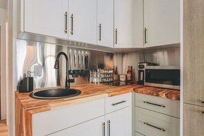 The gorgeous kitchen with wooden countertops.