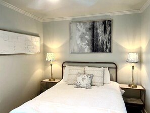 One Queen bed and smart TV in primary bedroom