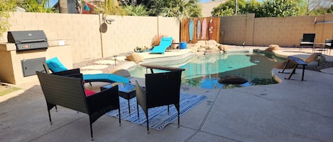 Pool area with waterfall and grill. outdoor seating for 12. 