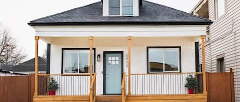 Stylish white home with blue door thats located on main street 6th Ave Tacoma.