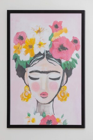 A framed colorful art piece adding charm and personality to the interior.

