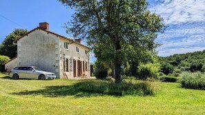 The house in its lush green garden