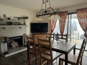 Our Gathering Room has a fireplace, dining table, 6 chairs, and 55” FireTV.