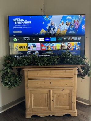 Our Gathering Room has a fireplace, dining table, 6 chairs, and 55” FireTV.