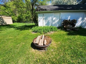 Gather around the firepit in the back yard.