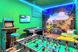 Minecraft themed games room with foosball, arcade game, air hockey and big screen TV