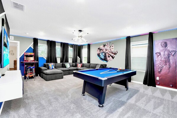 Upstairs Star Wars themed movie room with pool table and arcade games