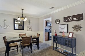 Entryway with Desk & Welcome Sign - Step into Island Retreat #6 through this welcoming entryway, featuring a handy desk and stylish décor.