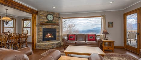 Living room with gas fireplace, sofa, arm chairs, TV & views!